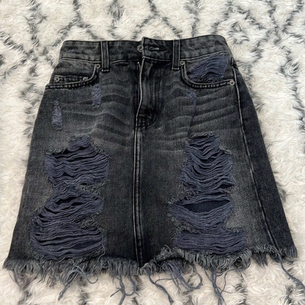 Distressed black denim mini skirt